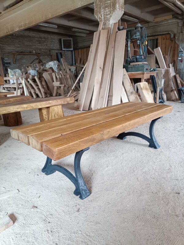 Backless solid oak bench with cast iron legs.